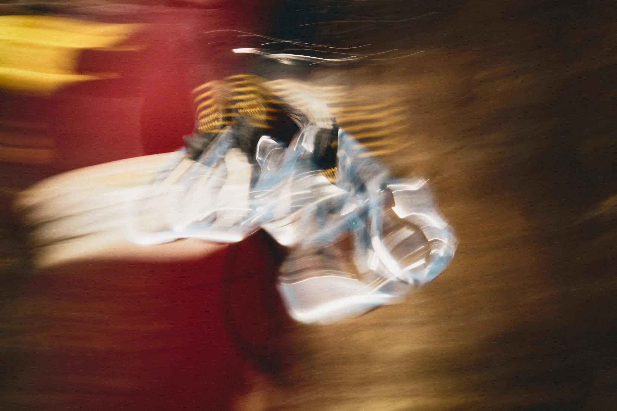 Abstract motion blur of climbing gear in motion, creating dynamic streaks of color and light