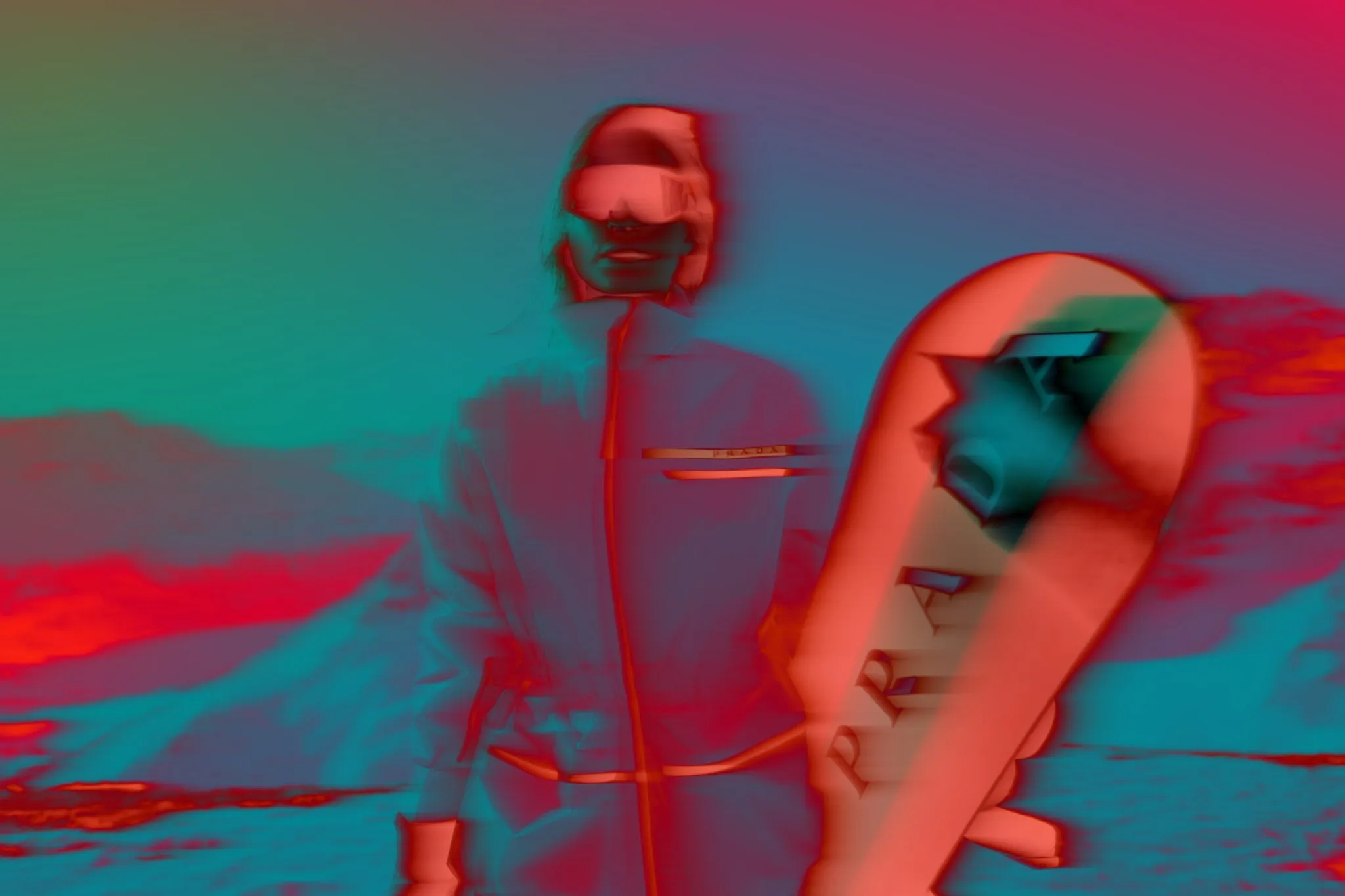 A stylized and color-manipulated image of a woman in ski gear, holding a snowboard. The colors are highly saturated with red and teal overlays, producing a surreal, almost infrared look. The image merges fashion and landscape in an abstract, graphic way.