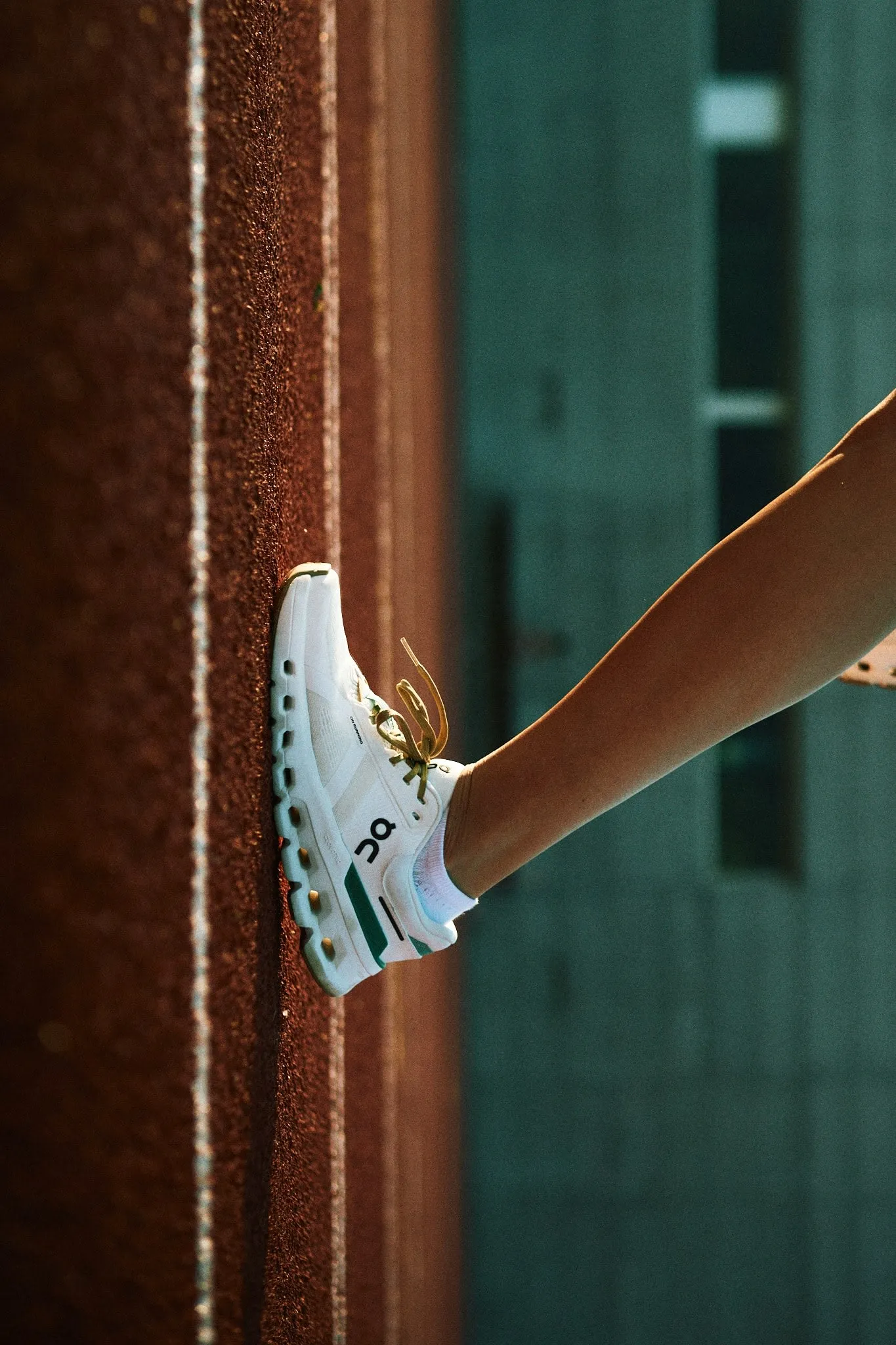 Fashion-forward female model wearing ON brand shoes, styled with clean, contemporary essentials.