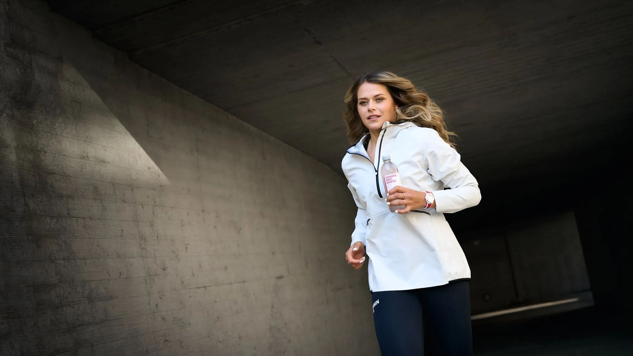 Dynamic close-up of Corinne Suter, elite Swiss ski racer, smiling confidently during an outdoor lifestyle shoot, blending athleticism and elegance.